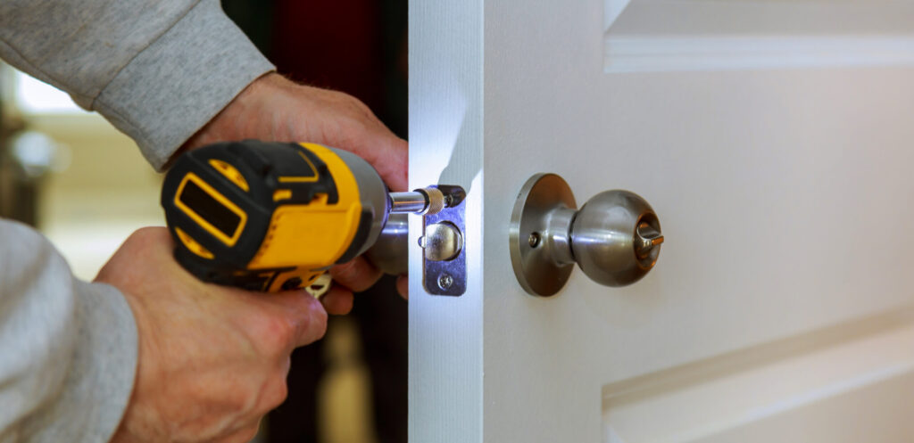 Carpenter Install Door Lock Using Screwdriver At Home